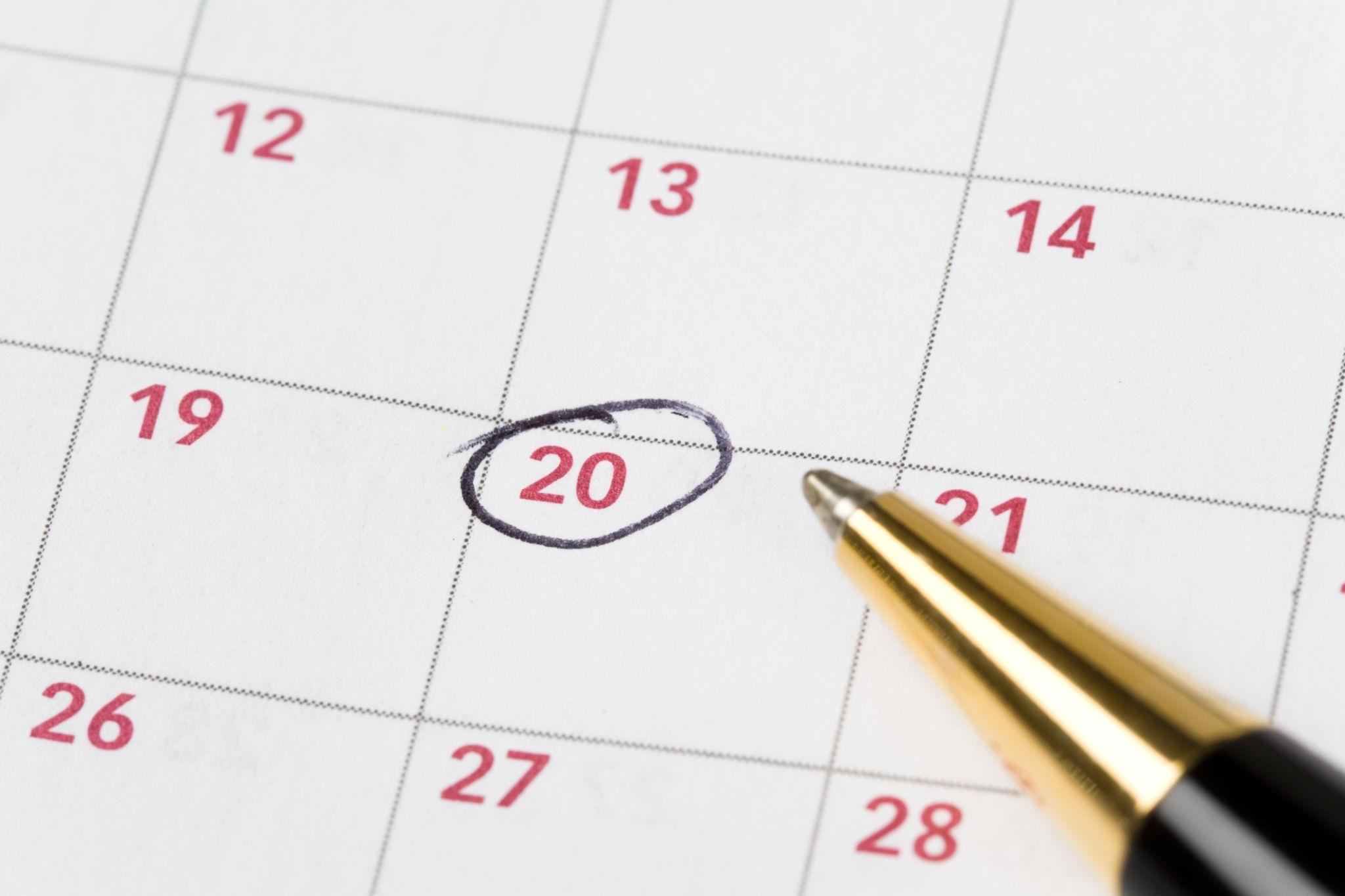 Open paper calendar on a desk, representing a change of performance date